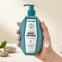 Hand holding a bottle of Kyn Loom body lotion with a blurred background